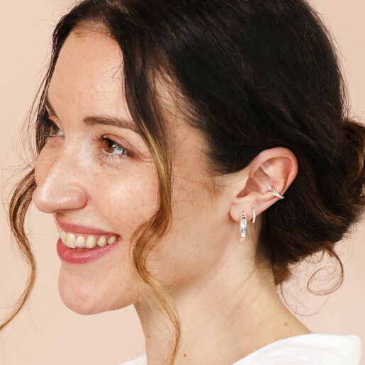 A Sparkly Silver Open Backed Earring With Added Crystals and a Twist Effect