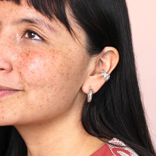 nature inspired ear cuff in silver on model layered with silver hoop earring