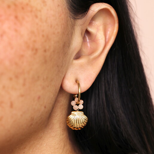Stainless Steel Shell Charm Hoop Earrings in Gold close up on model