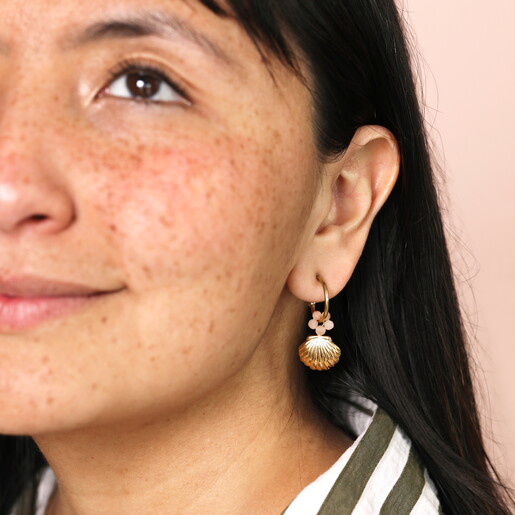 Stainless Steel Shell Charm Hoop Earrings in Gold on model