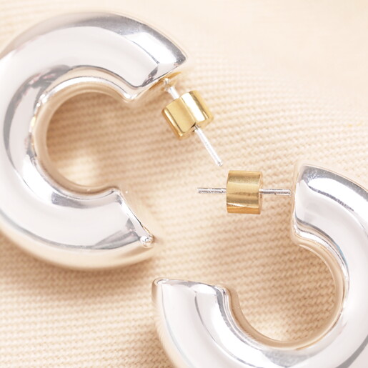 Close Up of Surface Silver Chunky Hoops with Gold Bullet Push Backs