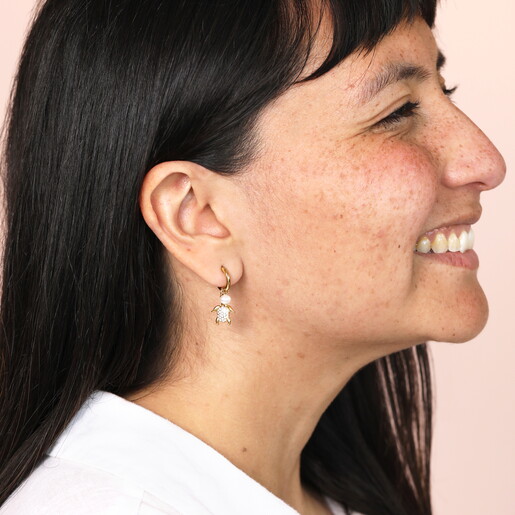 seaside huggie hoop earrings in gold on model