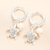 Silver Tiny Huggie Hoops Earrings With Dangling Turtle Charms and Added Sparkles Alongside Freshwater Pearl Charms