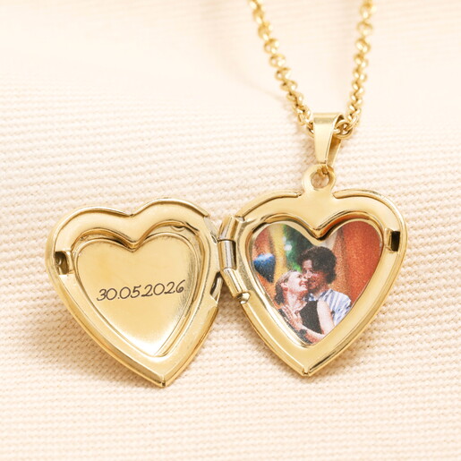 A Heart Shaped Photograph Inside an Open Heart Shaped Locket With a Personalisation Next to it