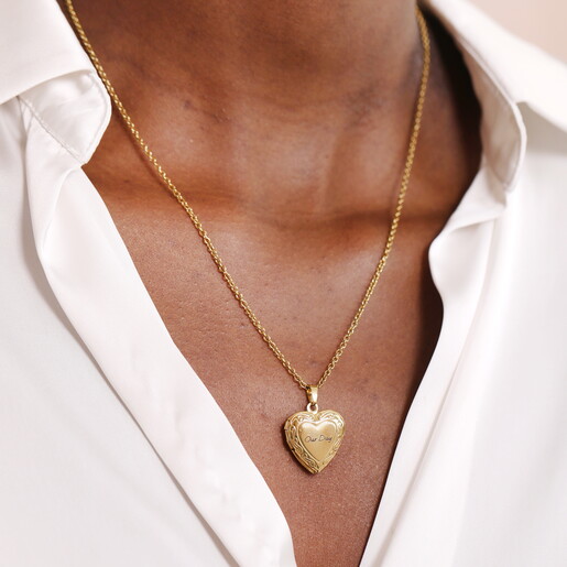 A Gold 3D Heart Shaped Pendant With an Engraving on the Front