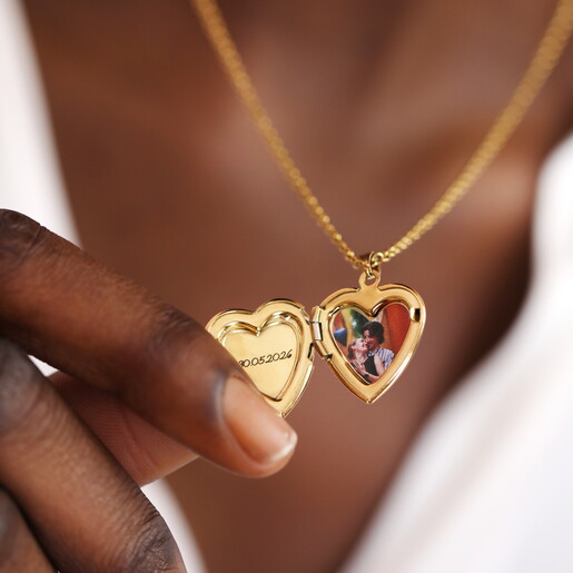 A Gold 3D Heart Shaped Pendant With an Engraving on the Front