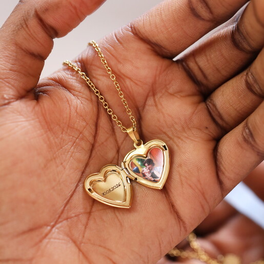 A Gold 3D Heart Shaped Pendant With an Engraving on the Front