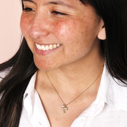 pearl and dolphin pendant necklace in gold on model