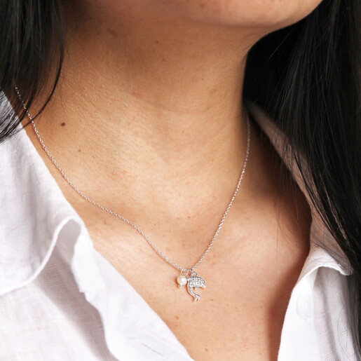 dolphin pendant necklace with cubic zirconia crystals in silver close up on model