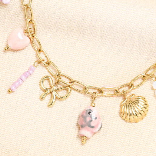 Close Up of Shell Bow and Bead Charms on Chunky Gold Chain Necklace