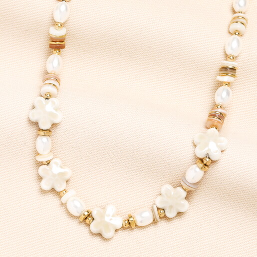 A Beaded Necklace With Gold and Pearl Accents Finished With Flower Shaped Beads
