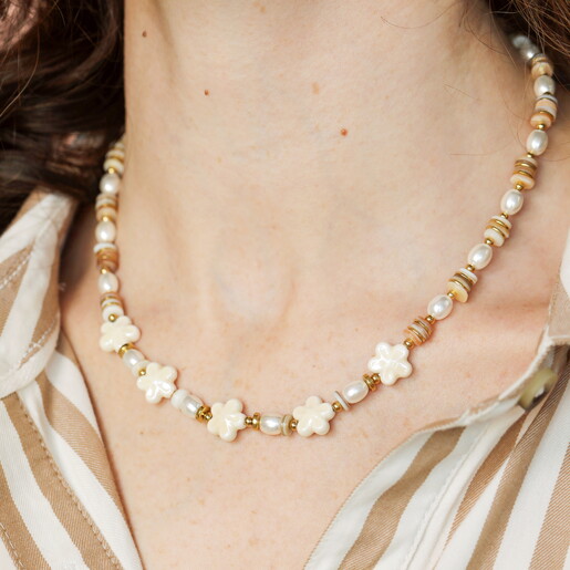 A Beaded Necklace With Gold and Pearl Accents Finished With Flower Shaped Beads