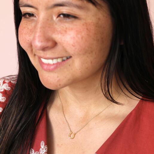 Gold Horseshoe Charm Necklace with Clean Engraving on Model