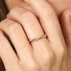 elegant ring in gold against pale pink background
