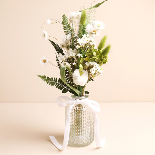 A Pretty Dried Flower Posy of Greens and Whites in a Glass Vase with a Ribbon Detail