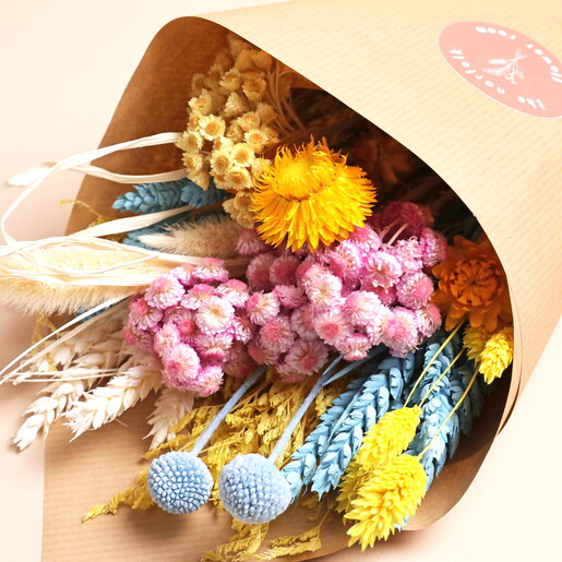 hand arranged flowers in kraft paper