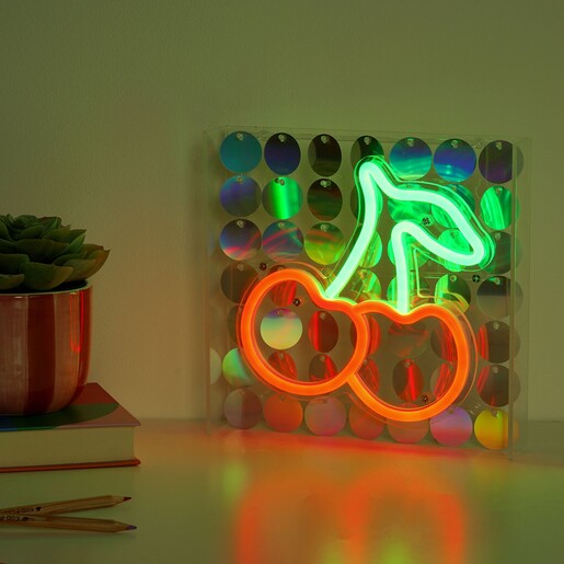 A Light Up Red and Green Cherry Sign with Reflective Discs