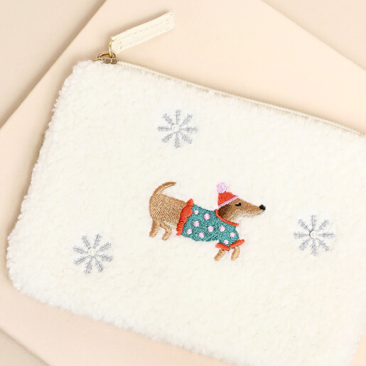 Close-up of the embroidered dachshund wearing a festive jumper and bobble hat.