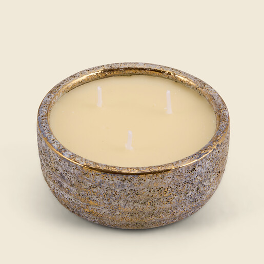 Top view of St Eval three-wick candle in textured pot with gold rim.