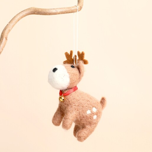 Felt leaping reindeer decoration hanging from a branch by a white thread loop