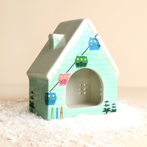 Back opening of ceramic ski chalet tealight holder with cable car illustration