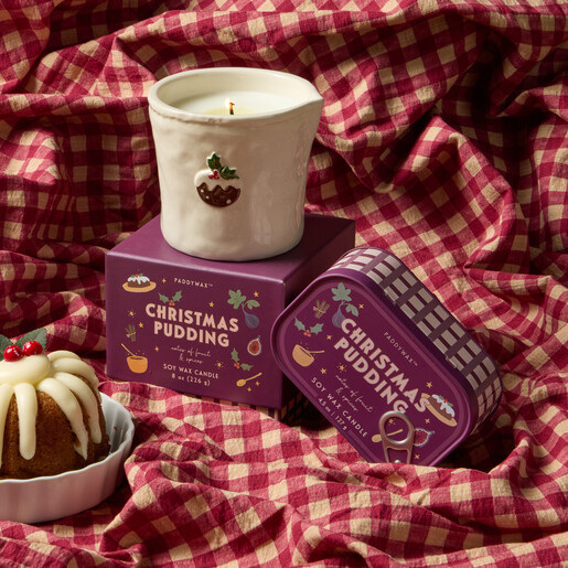 Paddywax Christmas pudding bistro tin candle displayed on festive red gingham fabric.