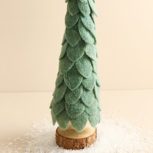 Close up of layered sage green felt foliage and natural wooden base