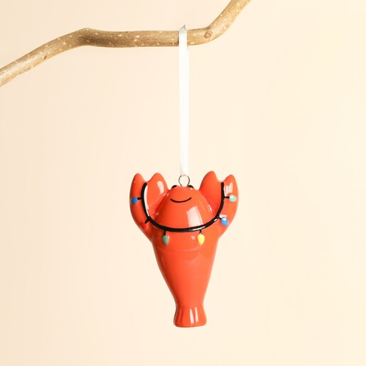 Ceramic Christmas lobster hanging decoration suspended from a branch by a white ribbon loop