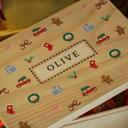 Close-up of wooden box lid printed with seasonal designs and personalised name