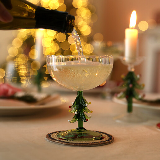 lifestyle shot of cocktail glass in green