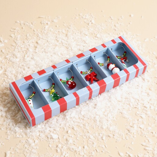 Set of six festive glass wine glass charms in a striped gift box.