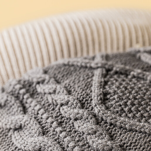 Close-up of grey cable-knit fabric on the Jellycat Pomilly soft toy