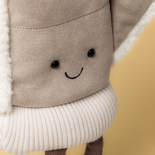 Close-up of the smiling face on the mitten soft toy