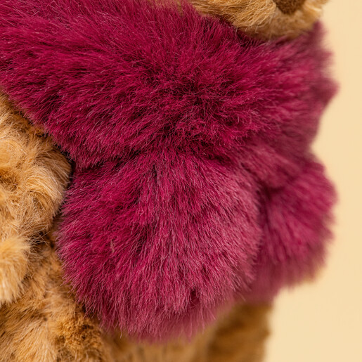 Close-up of the textured fluffy berry-coloured winter scarf