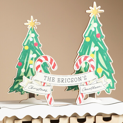 Close up of personalised candy cane and Christmas tree advent topper banner