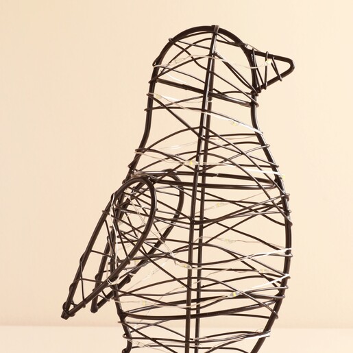 Close-up of black wire penguin light detailing the woven fairy lights