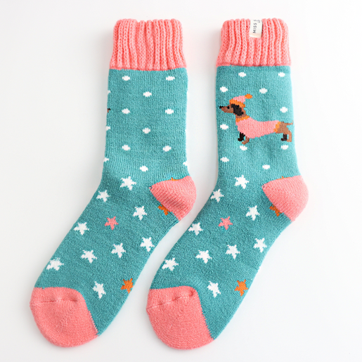 Pair of teal Miss Sparrow festive socks with dachshunds and pink ribbed cuffs.