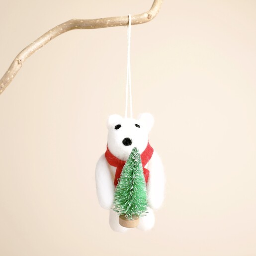 Front view of white felt polar bear hanging decoration holding a Christmas tree