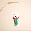 Front view of white felt polar bear hanging decoration holding a Christmas tree
