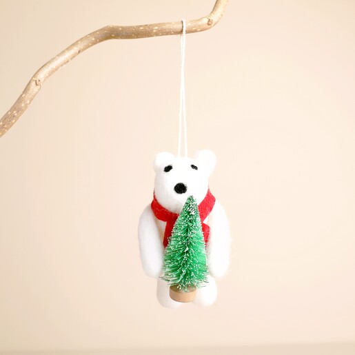 Front view of white felt polar bear hanging decoration holding a Christmas tree