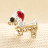 Close-up view of sterling silver sausage dog stud earring with crystal Santa hat