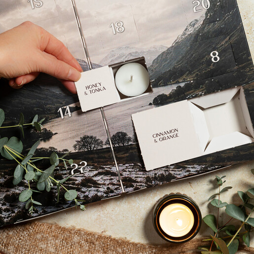 Opening a door on the Pintail tea light advent calendar revealing a candle