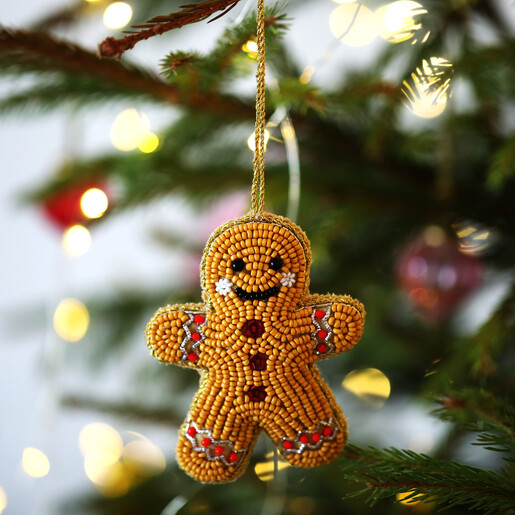 Beaded gingerbread man hanging ornament displayed on a Christmas tree branch