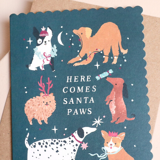 Close-up of festive dogs on the scalloped Santa Paws Christmas card