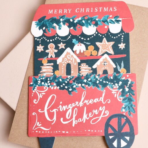 Close up of gingerbread bakery Christmas card showing cart illustrations