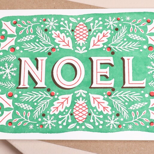 Close up of NOEL lettering and winter foliage on Stormy Knight Christmas card