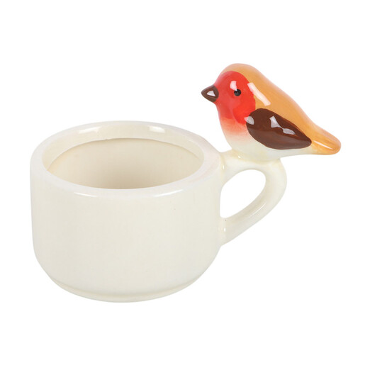 Side view of cream ceramic tealight cup with a perched robin on the handle