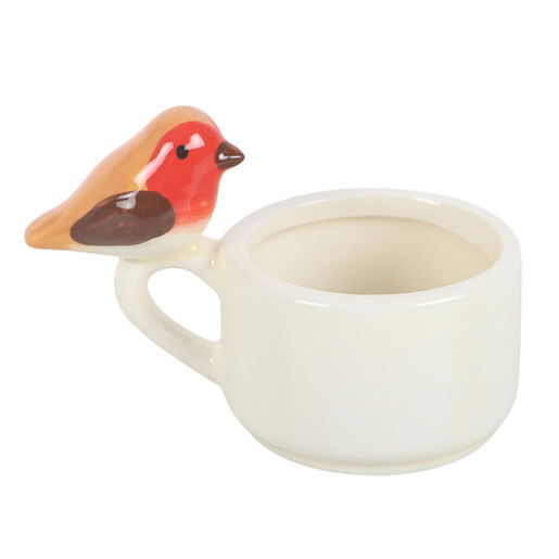 Empty cream ceramic teacup tealight holder showing the robin perched on the handle