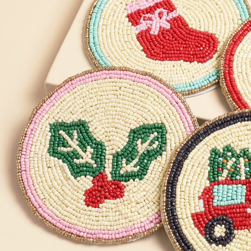 Close-up detail of the intricate beadwork on the festive holly design coaster