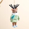 Close-up of reindeer felt Christmas hanging decoration with green jacket and mini tree